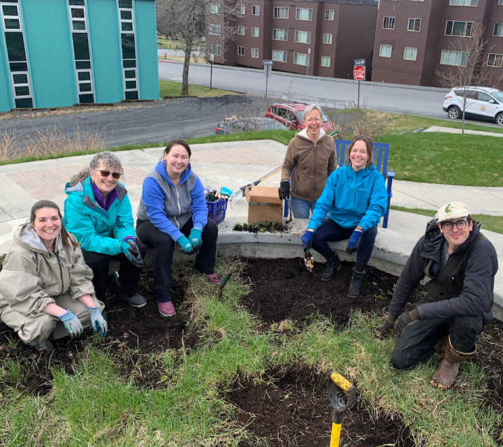 Salmon filets hanging from the rafters in a smokehouse