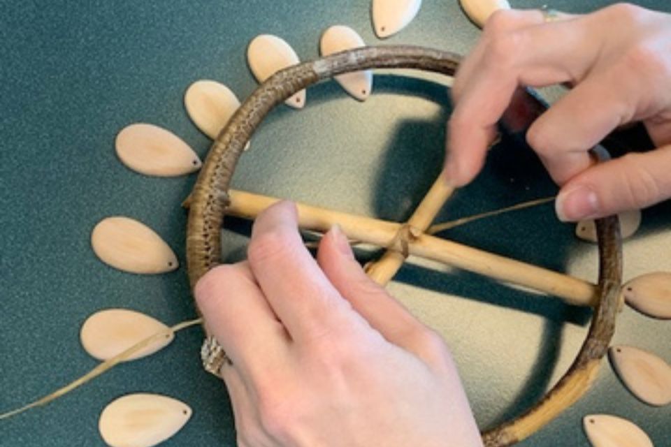 Young man sitting in front of a computer with a microphone.